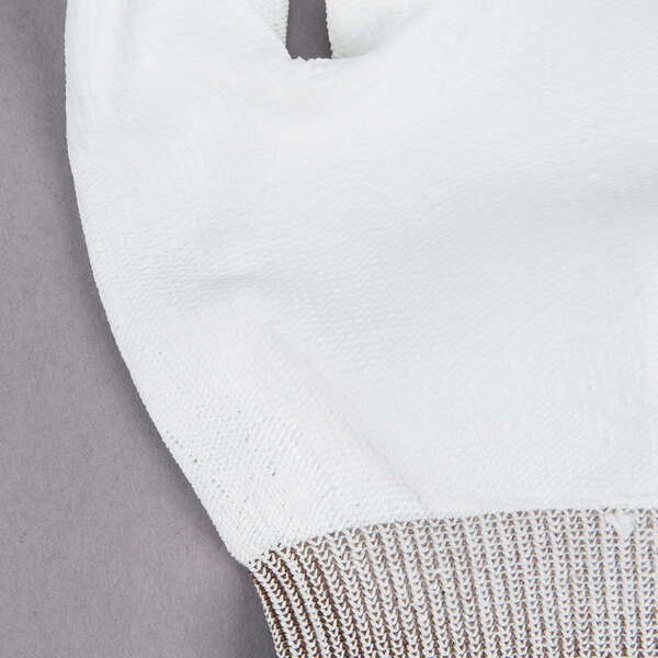 A close-up of a Cordova white glove with brown trim.