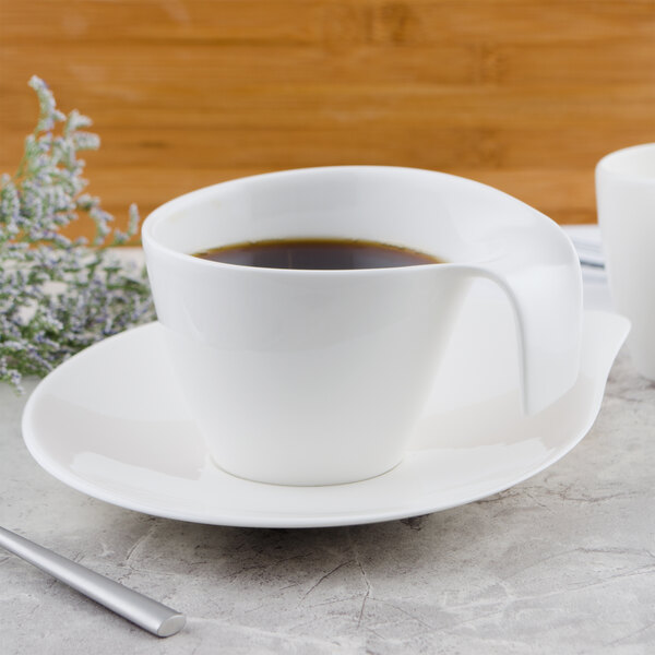 A Villeroy & Boch white porcelain cup on a saucer with coffee