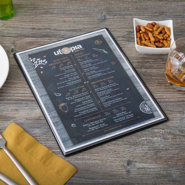A Menu Solutions Hamilton menu on a table with a glass of wine and a fork.