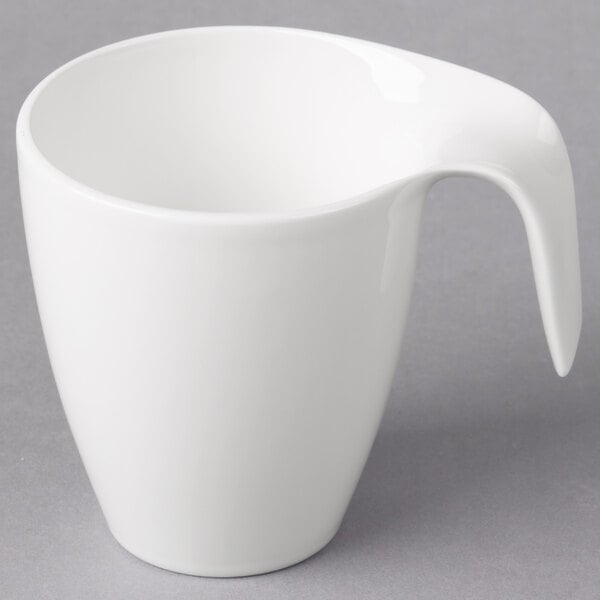 A close-up of a Villeroy & Boch white porcelain mug with a handle.