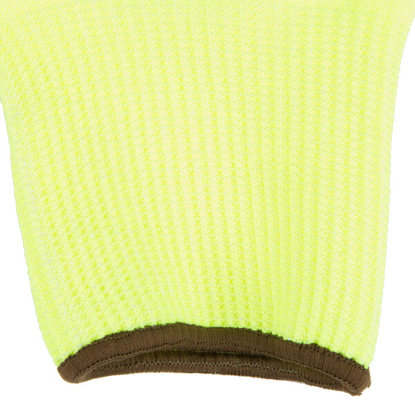 A close up of yellow knit gloves with brown trim on the wrist.