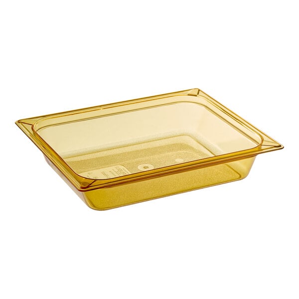 A Carlisle amber plastic food pan on a counter.