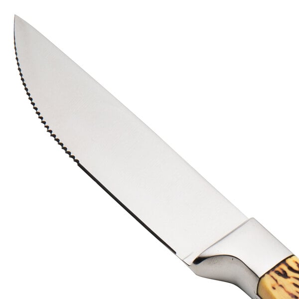 A Walco stainless steel steak knife with a wooden handle.