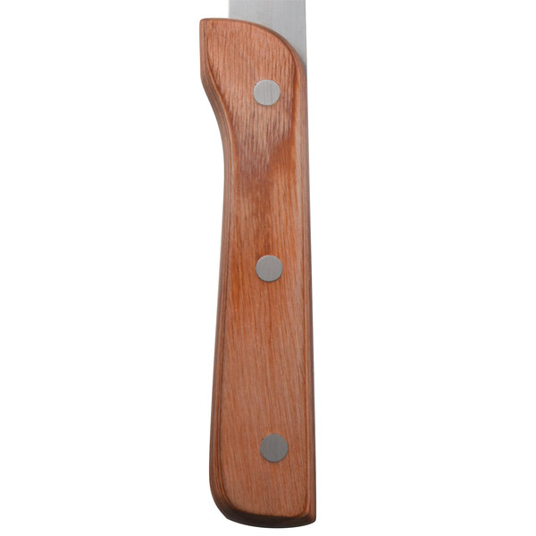 A Walco stainless steel steak knife with a brown Pakka wood handle.