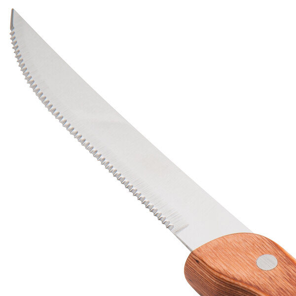 A Walco stainless steel steak knife with a brown Pakka wood handle.