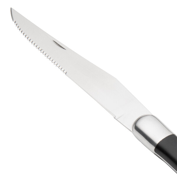 A Walco stainless steel steak knife with a black Delrin handle.