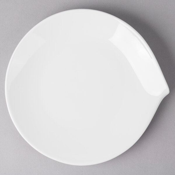 A white Villeroy & Boch porcelain flat plate with a small hole in the middle.