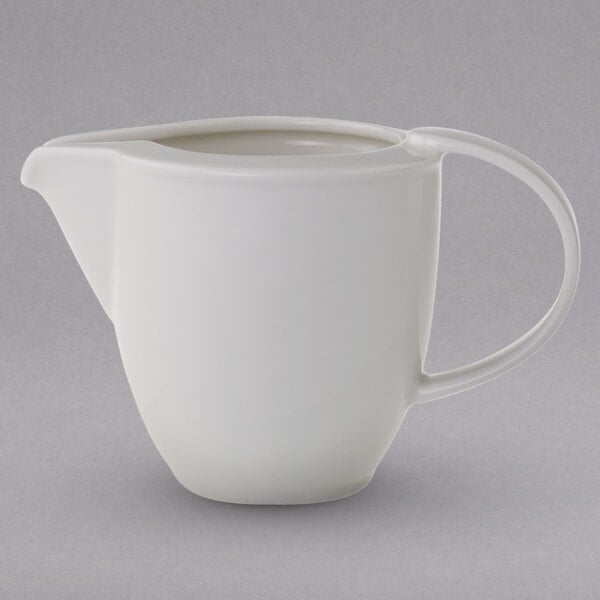 A Villeroy & Boch white porcelain creamer with a handle.