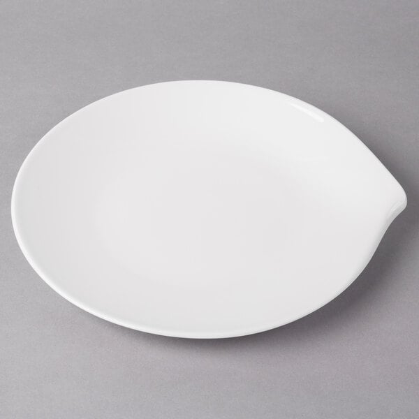 A Villeroy & Boch white porcelain flat plate with a curved edge.