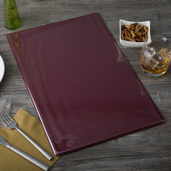 A red rectangular Menu Solutions Hamilton menu board on a table with a bowl of food and a fork.