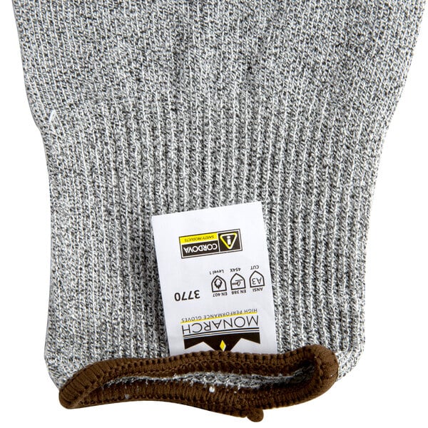 A pair of grey Cordova Monarch gloves with a white label.