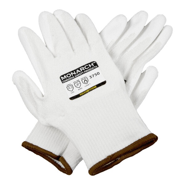A pair of white cut-resistant work gloves with brown trim and a polyurethane palm coating.
