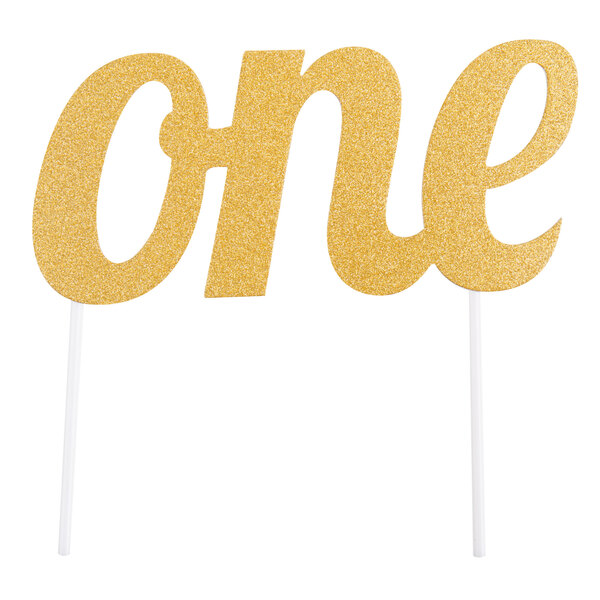 A gold glittered "One" cake topper on a white stick.