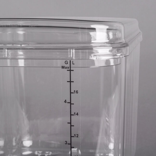 A close up of a clear plastic Crathco beverage dispenser bowl.