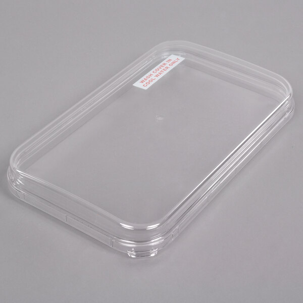 A clear plastic Crathco beverage dispenser bowl with a lid.