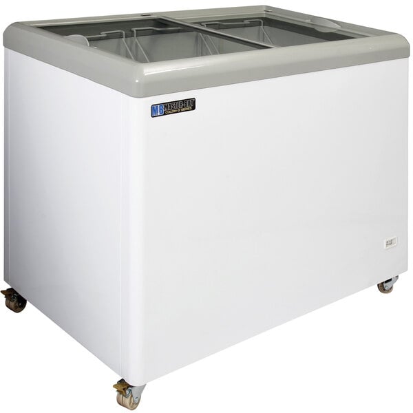 A white Master-Bilt flat top display freezer with wheels.