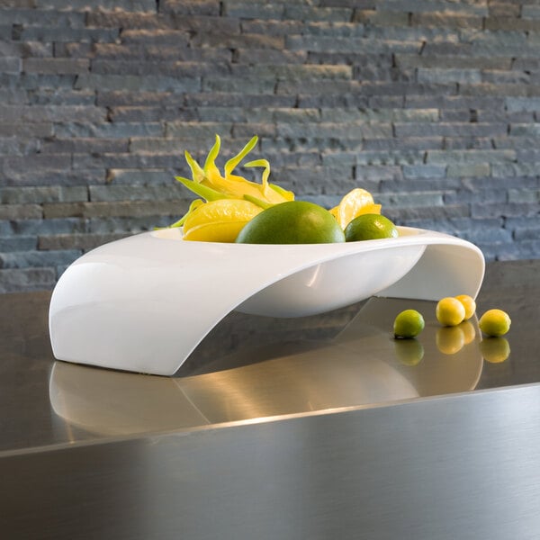 A white Villeroy & Boch porcelain bowl with fruit in it on a counter.