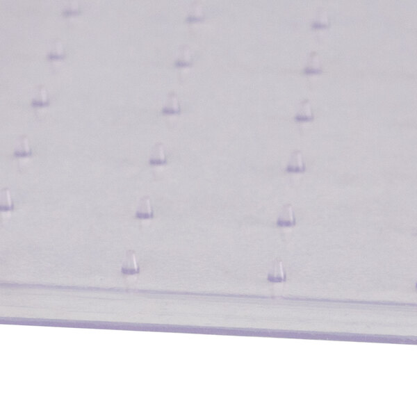 A close-up of a clear plastic Flash Furniture office chair mat with a lip and small grippers on the bottom.