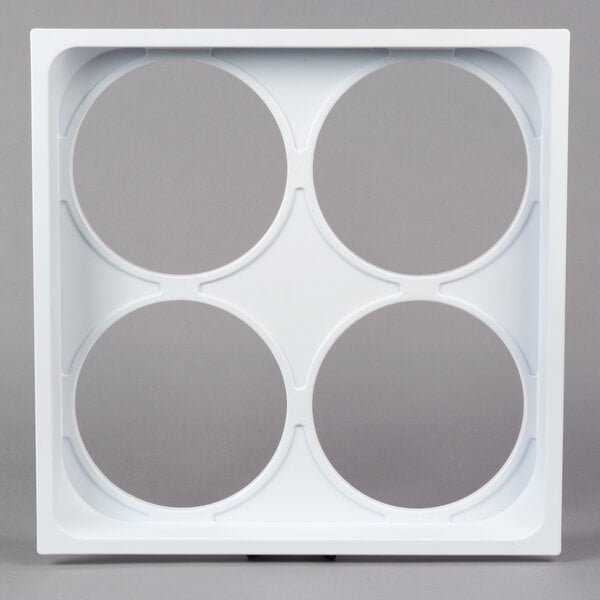 A white square object with four circular holes.
