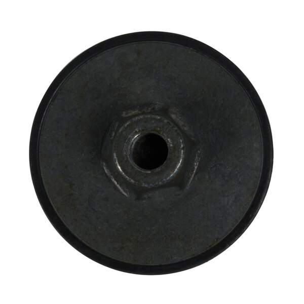 A close-up of a black circular drive coupling.