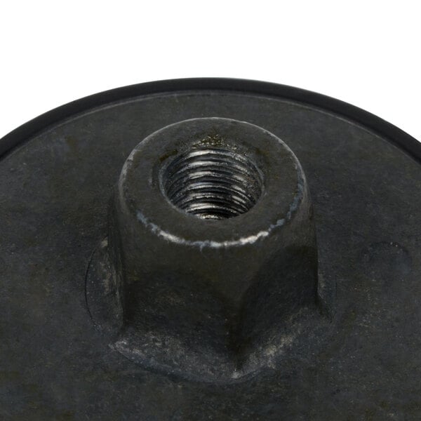 A close-up of a black metal nut with a screw on it.