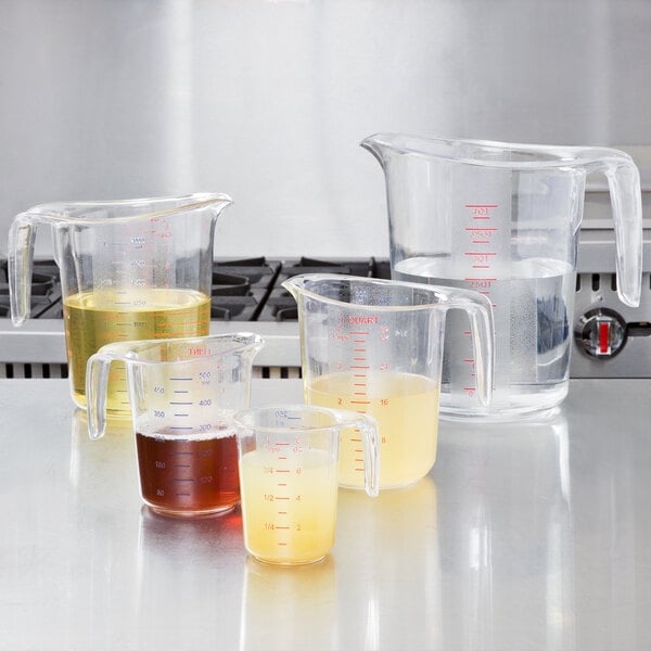 A liquid measuring cup set with each cup filled with various liquids