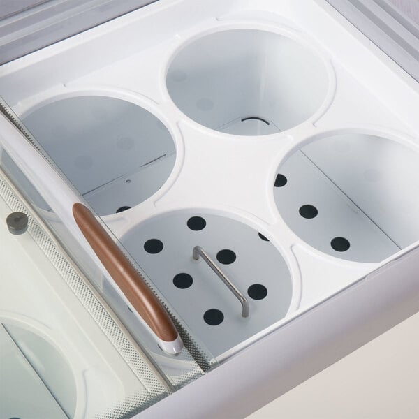 A white Avantco 4-hole can holder on a counter in a professional kitchen.
