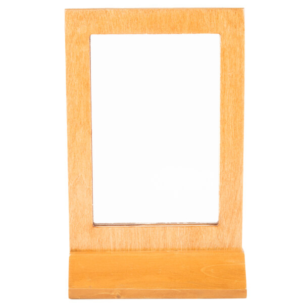 A Menu Solutions Country Oak wood menu tent with an angled base in a wooden frame.