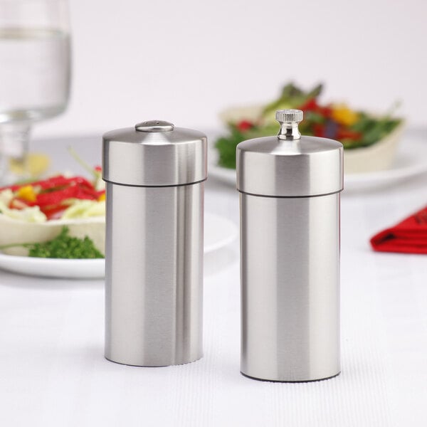 Two salt and pepper shakers on a table.