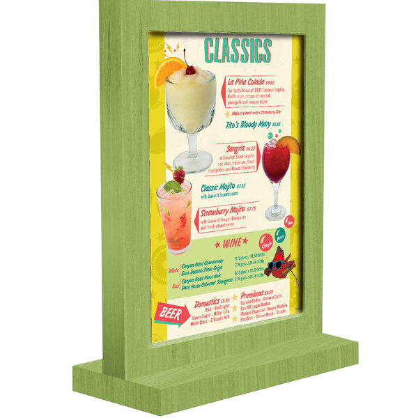 A Menu Solutions lime wood table tent with a glass display on a table in a cocktail bar.