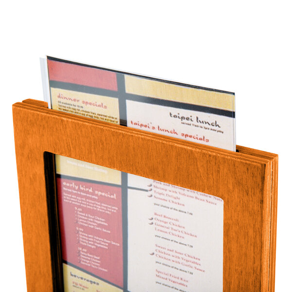 A Menu Solutions Mandarin wood menu tent on a table with a menu in it.
