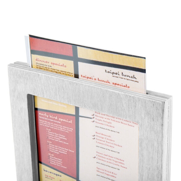 A Menu Solutions white wood framed menu tent with angled base holding a menu.