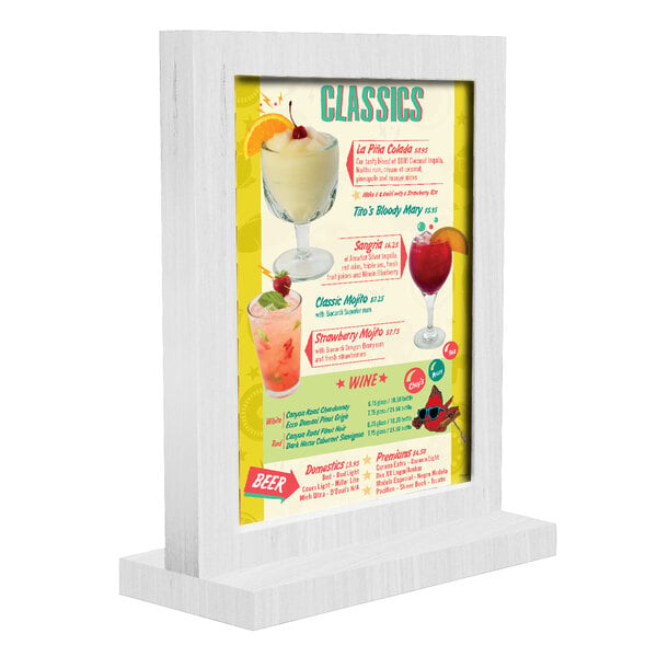 A white wood framed menu tent for a drink menu on a table.