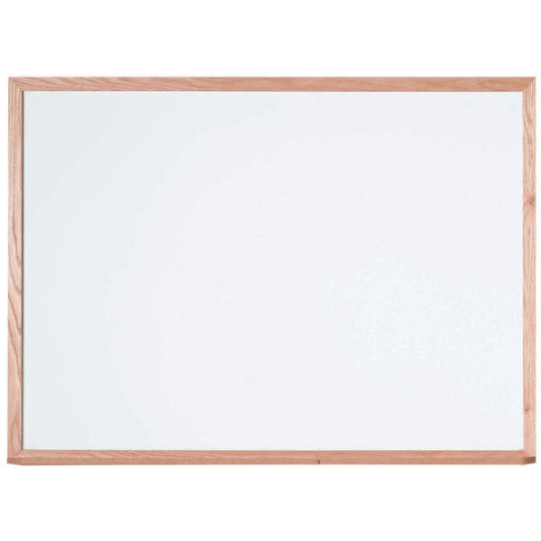 An Aarco white porcelain enamel markerboard with a red oak wood frame.