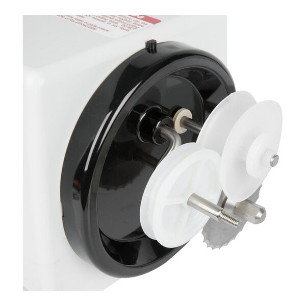 A close-up view of a mechanical device with white and black plastic components and a small circular saw blade.