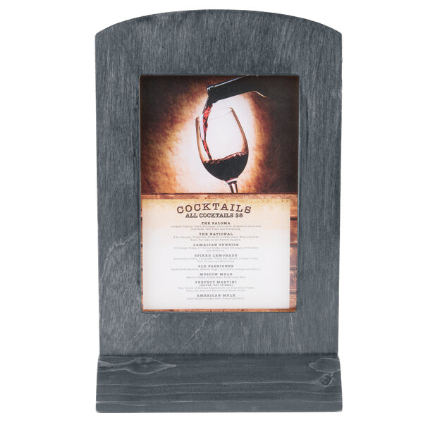 A Menu Solutions wood menu tent with a picture of a wine glass on it.