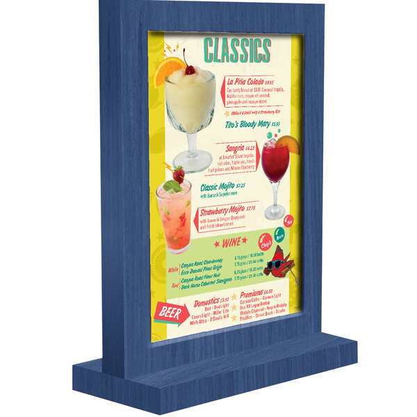 A Menu Solutions True Blue framed wood table tent on a table with drinks.