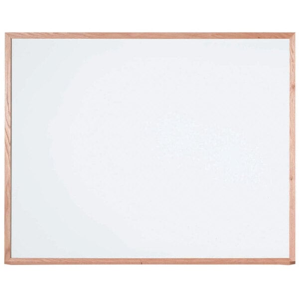 A white board with a solid wood frame.