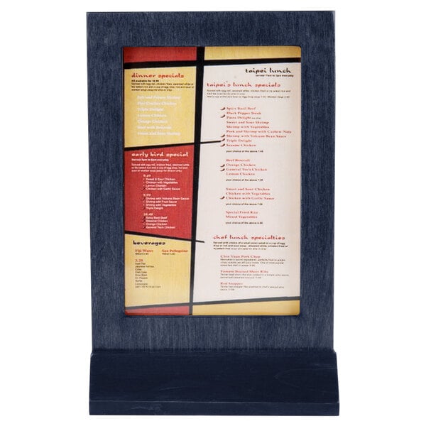 A Menu Solutions wood table tent with a denim frame holding a white menu with black text.