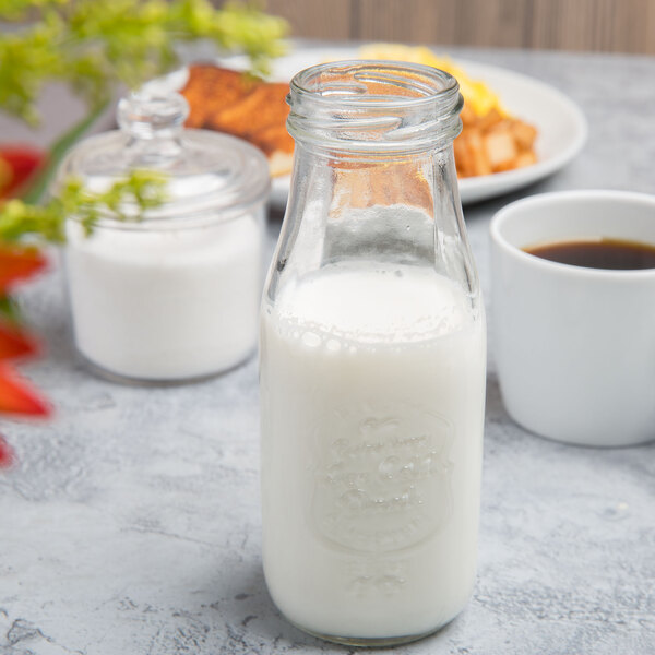 Acopa 10 oz. Embossed Glass Milk Bottle with Lid - 12/Case