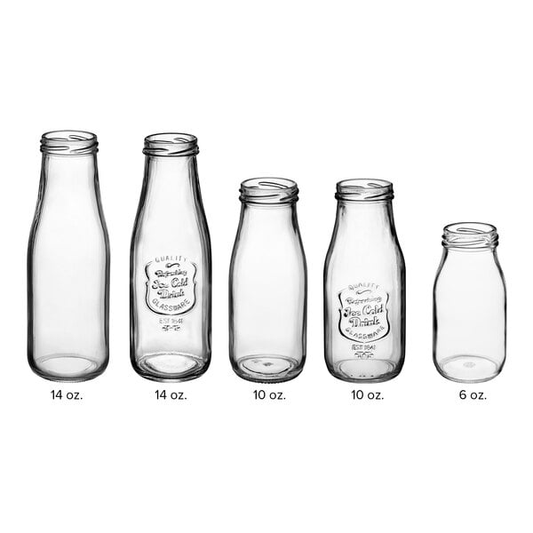 An Acopa clear glass milk bottle with an embossed label and black lid.