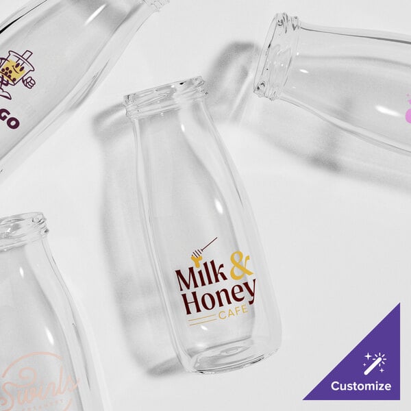 A group of empty Acopa glass milk bottles.