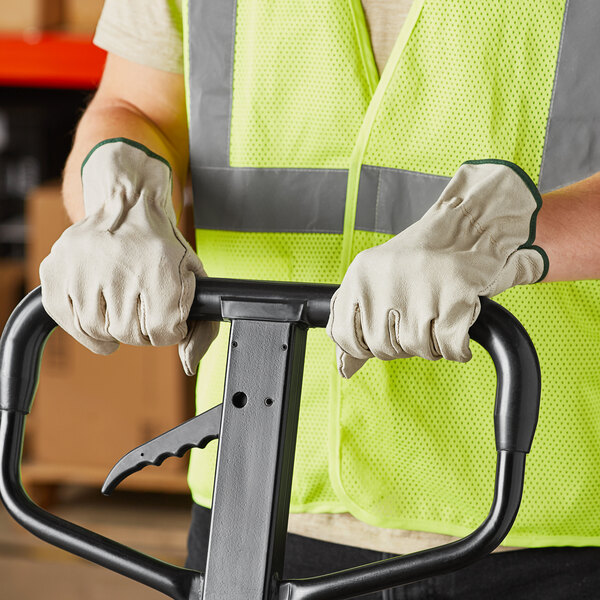 A person wearing Cordova Economy pigskin driver's gloves holding a forklift.
