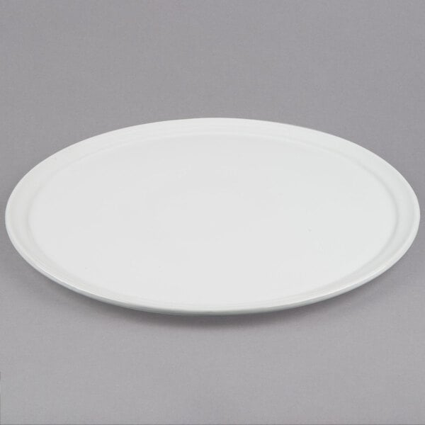 An American Metalcraft white ceramic pizza serving tray on a gray surface.