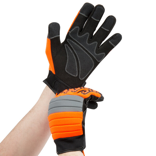 A person wearing Cordova orange and black warehouse gloves.