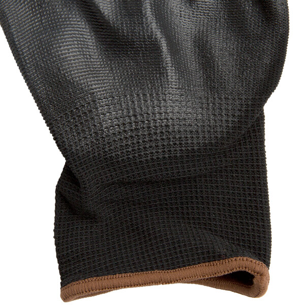 A black and brown Cordova warehouse glove with black polyurethane coating on the palm.