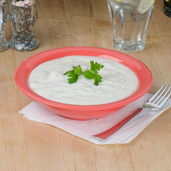 a bowl of white sauce with parsley on top