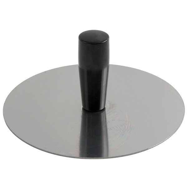 A circular stainless steel mold pack down tool with a black handle.