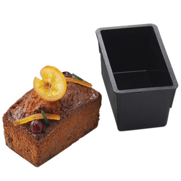 A loaf of bread baked in a black Matfer Bourgeat non-stick loaf pan with a slice cut off.