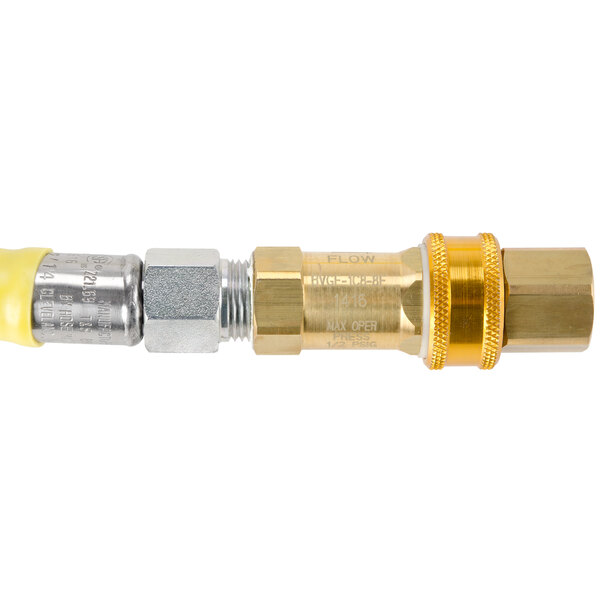 A brass T&S Safe-T-Link gas hose with yellow connectors.